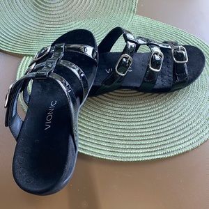 Black patent leather sandals.